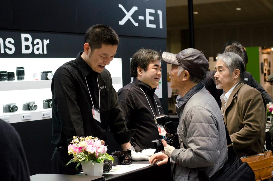 Staff and customers chat about the new X-E1 at the Fuji Camera Lens Bar.