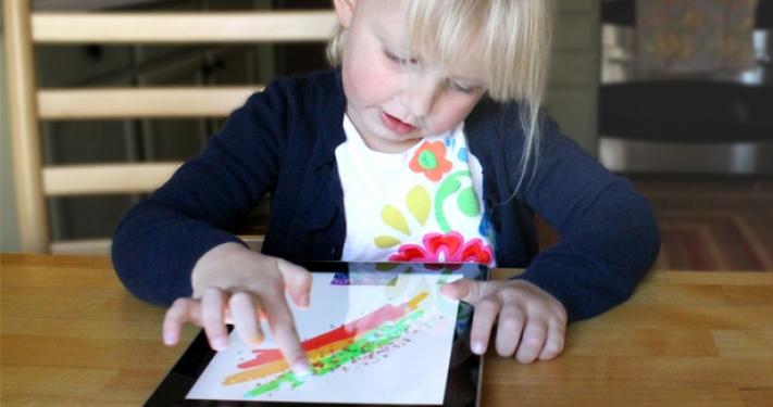Child playing using touchscreen